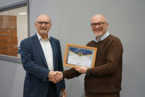 Dave Mooney receiving his retirement certificate from John Staplehurst